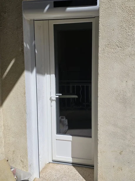 Porte fenêtre blanche PVC Réhau et volet roulant solaire Profalux Saint-Étienne-des-Sorts vue extérieure